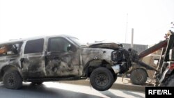 A vehicle is towed from the scene of a suspected suicide car bomb attack in Kabul.