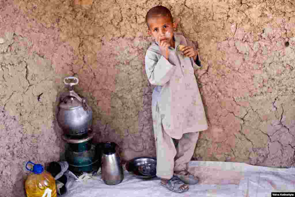 Asadullah, 7, lives in a mud-brick house with his family of eight. 