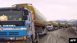 A convoy of NATO supply trucks prepare to cross into Afghanistan near the border town of Chaman in 2009.