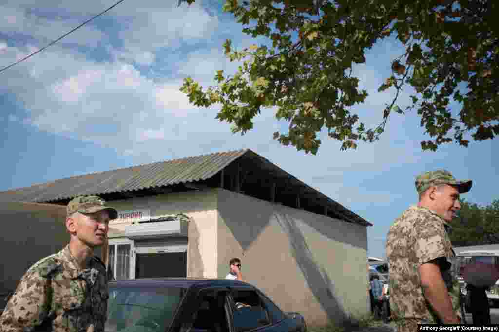 Security forces outside the large market in the southern town of Gali 