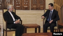 Syrian President Bashar al-Assad (right) meets with Iranian Supreme National Security Council Secretary Said Jalili in Damascus on February 3.