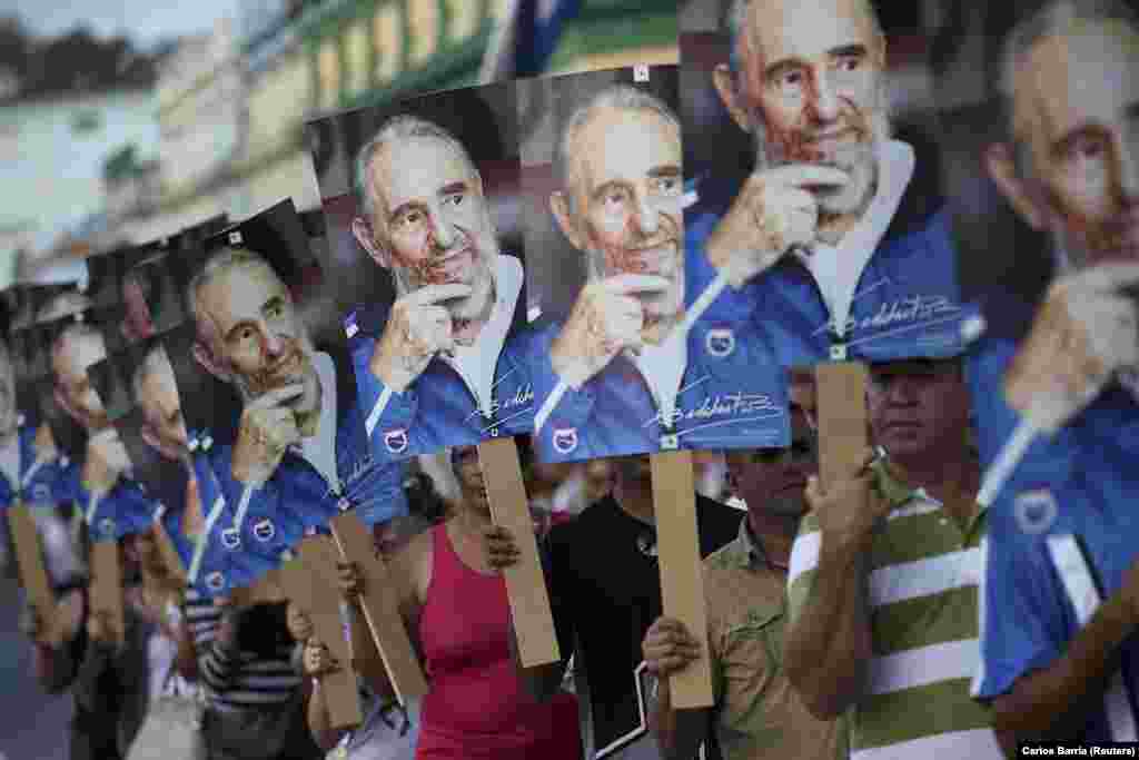 People hold posters of late Cuban leader Fidel Castro while awaiting the arrival of a procession carrying his ashes in Las Tunas, Cuba, on December 2. Castro, who ruled Cuba as a one-party state for almost half a century, died aged 90 on November 25. (Reuters/Carlos Barria)