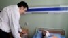 President Saakashvili visiting a patient at a military hospital in Gori on August 9