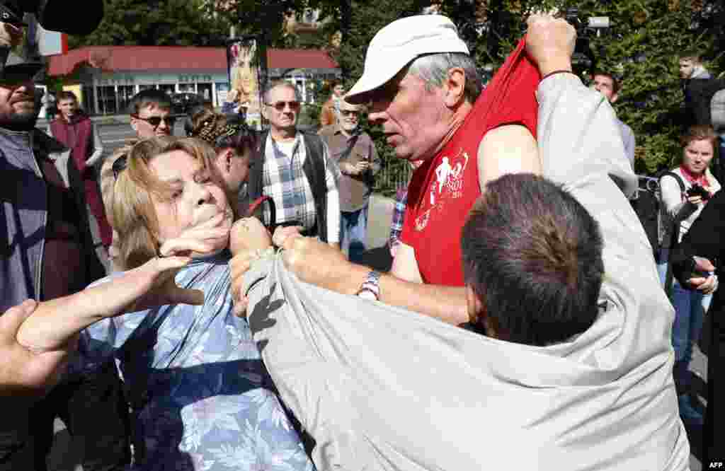 People scuffle in front of the Russian Embassy in Kyiv during elections for Russia's State Duma on September 18. (AFP/Anatoliy Stepanov)