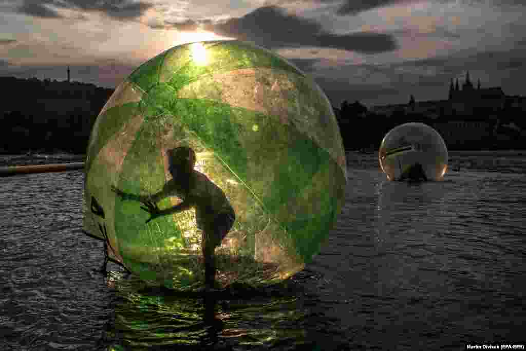 A boy goes zorbing on the Vltava River during a warm summer&#39;s day in Prague. (epa-EFE/Martin Divisek)