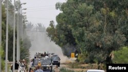 Anti-Qaddafi fighters push forward during heavy fighting towards the center of Sirte on October 7.