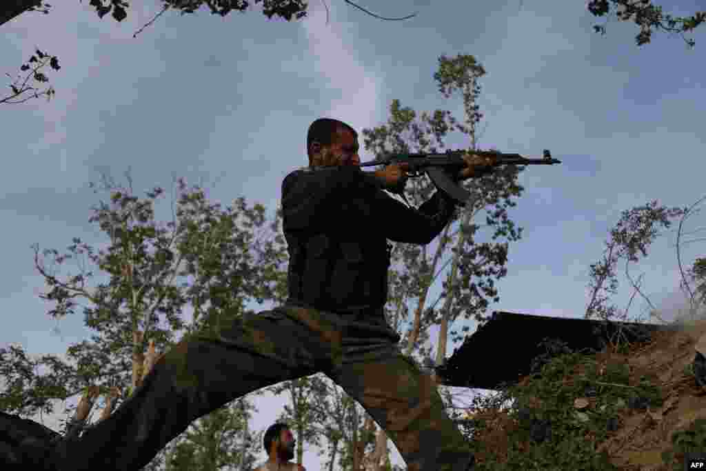 A Syrian rebel fighter aims his weapon on the front line against regime forces in the rebel-controlled village of Bala on the outskirts of the capital Damascus. (AFP/Abdulmonam Eassa)