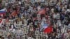 People carry pictures of World War II soldiers as they take part in the Immortal Regiment march during the Victory Day celebrations in central St. Petersburg on May 9.