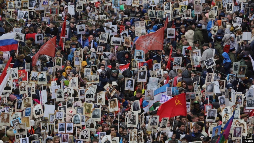People carry pictures of World War II soldiers as they take part in the Immortal Regiment march during the Victory Day celebrations in central St. Petersburg on May 9.