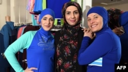 Muslim models display burkini swimsuits at a shop in Sydney.