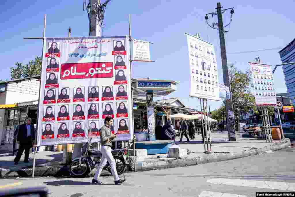 Photos of girls who get high university entry test scores are displayed on a street in Astara.