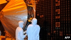 NASA's "Maven" spacecraft is checked by technicians in preparation for its November 2013 launch.