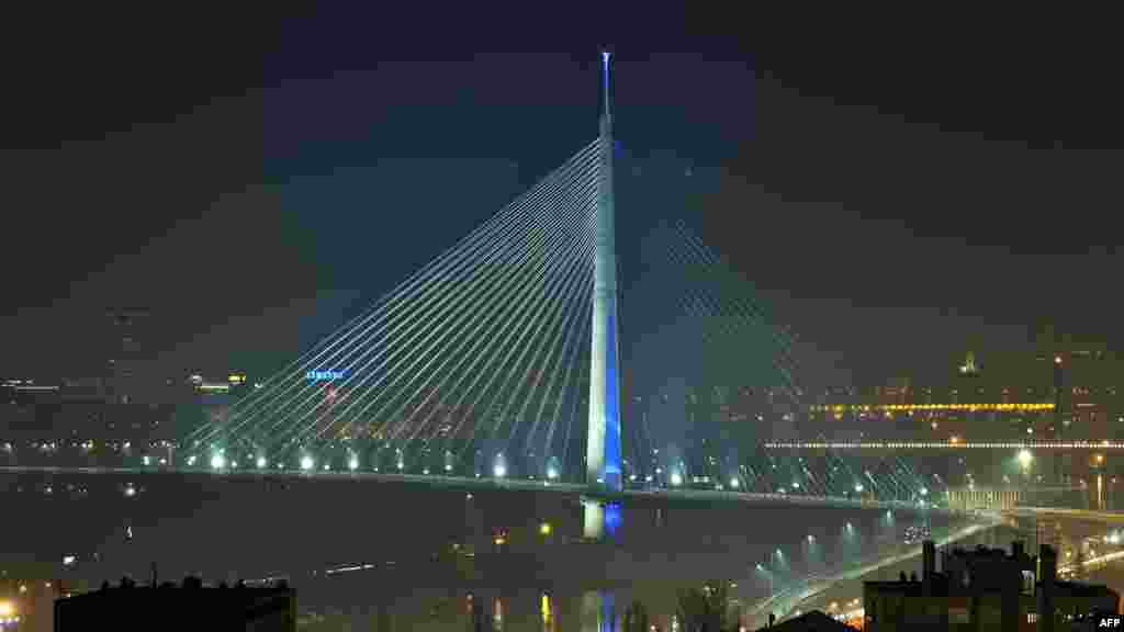 The newly built Ada Bridge over the Sava River is illuminated in Belgrade, Serbia, early on January 1. (AFP/Andrej Isakovic)
