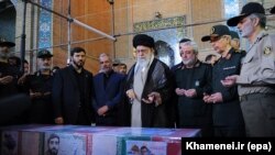 Iran's Supreme Leader Ayatollah Ali Khamenei (center) prays over the casket of Mohsen Hojaji, who was beheaded in Syria by Islamic State (IS) militants, in Tehran on September 27.