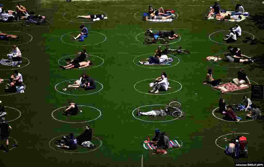 People are seen practising social distancing in white circles in Domino Park, during the Covid-19 pandemic on May 17, 2020 the in Brooklyn borough of New York City.&nbsp;