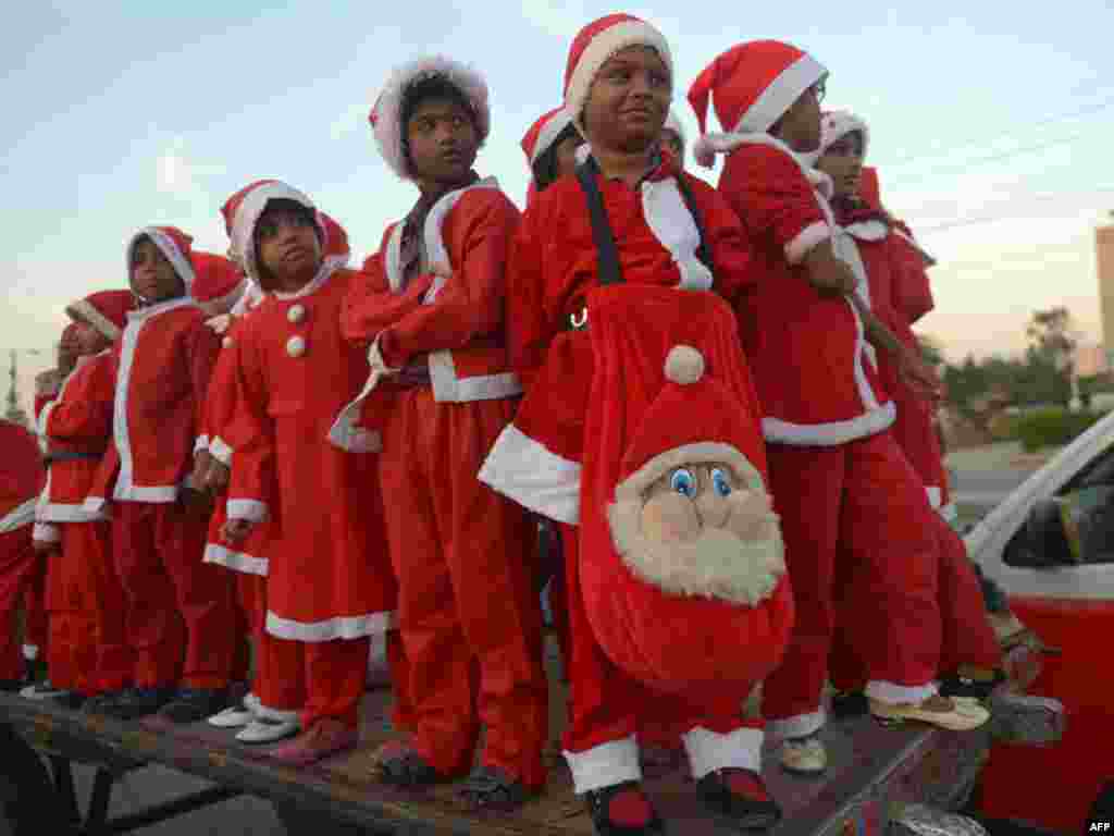 Pakistani minority Christian children dressed as Santa Claus pose in Karachi during a Christmas peace rally in solidarity of the victims of the Peshawar school massacre. (AFP/Rizwan Tabassum)