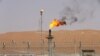 FILE PHOTO: Flames are seen at the production facility of Saudi Aramco's Shaybah oilfield in the Empty Quarter, Saudi Arabia May 22, 2018. . REUTERS/Ahmed Jadallah/File Photo