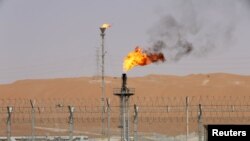 FILE PHOTO: Flames are seen at the production facility of Saudi Aramco's Shaybah oilfield in the Empty Quarter, Saudi Arabia May 22, 2018. . REUTERS/Ahmed Jadallah/File Photo