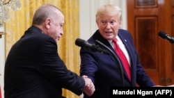 U.S. -- U.S. President Donald Trump and Turkish President Recep Tayyip Erdogan (L) take part in a joint press conference in the East Room of the White House in Washington, November 13, 2019