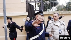 Police at work in front of the Chilean Embassy in Rome after a parcel bomb explosion