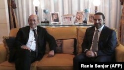 French Foreign Minister Jean-Yves Le Drian (left) meets with Lebanese Prime Minister Saad Hariri at the latter's residence in the Saudi capital, Riyadh, on November 16.