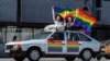 Gay-rights activists hold rainbow flags during a protest in central Moscow in May 2014.