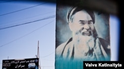 A poster of former warlord Abdul Ali Mazari hangs along a street in Mazar-e Sharif in June 2015.