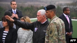 U.S. Vice President Mike Pence (center) talks with U.S. General Vincent K. Brooks (right), commander of the United Nations Command, Combined Forces Command, and United States Forces Korea, as they visit Observation Post Ouellette near the truce village of Panmunjom.
