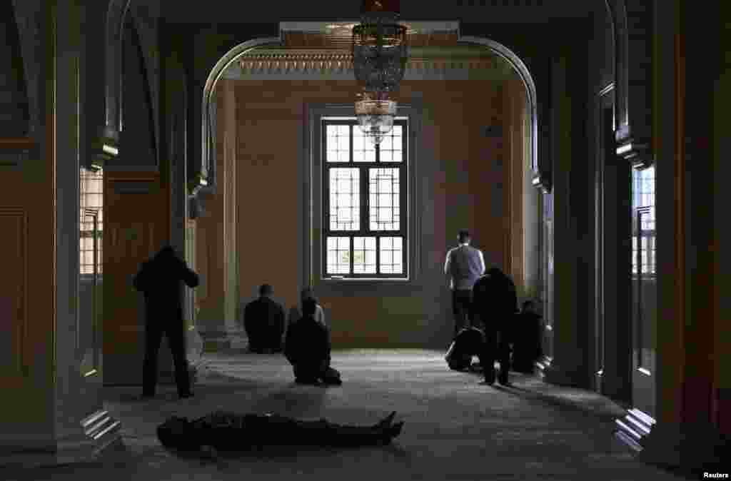 Men wait for Friday prayers to begin at the Heart of Chechnya Mosque.