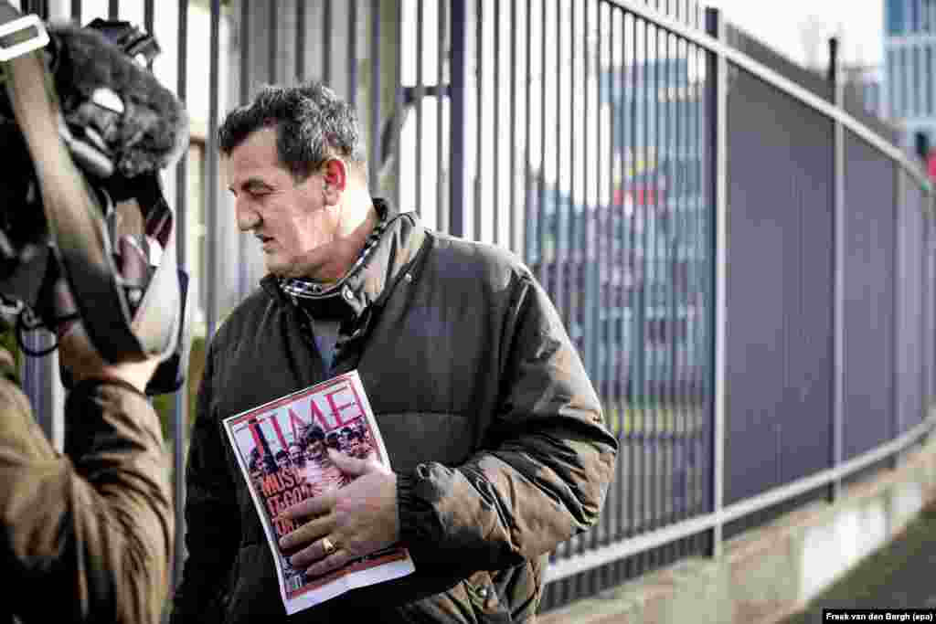 Visiting The Hague, Fikret Alic, holding the famous 1992 Time magazine cover on which he is shown, emaciated behind barbed wire in a Serb-controlled prison camp, awaits the verdict against Bosnian Serb military chief Ratko Mladic on November 22. Mladic was sentenced to life in prison for genocide and war crimes during the Balkans war. (epa-EFE/Freek van den Bergh)