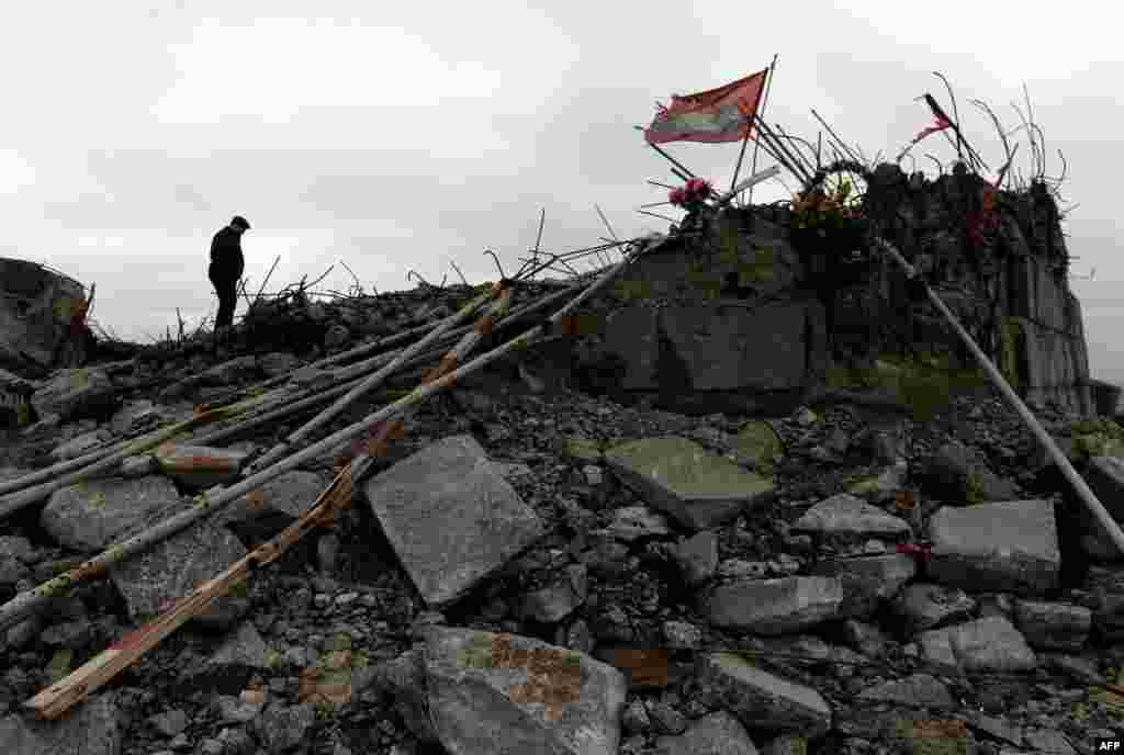 A man walks near the recently damaged Savur Mogila monument to Red Army soldiers fallen during World War II near the eastern Ukrainian city of Snizhnee. The memorial complex, built in 1963 to commemorate a 1943 World War II Soviet battle, was reduced to rubble after battles between Ukrainian forces and separatist soldiers. (AFP/Vasily Maximov)