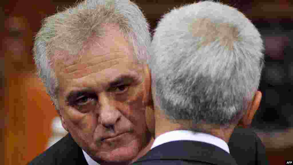 New Serbian President Tomislav Nikolic (left) embraces former President Boris Tadic as he takes his oath of office at the National Assembly building in Belgrade on May 31. Nikolic said he wanted Serbia to join the EU, but stressed that Belgrade would never give up its claim to Kosovo. (AFP/Andrej Isakovic)