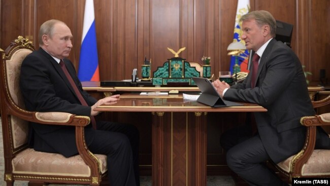 Russian President Vladimir Putin (left) speaks with Sberbank CEO German Gref during a meeting in Moscow in September 2019.