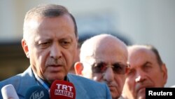 Turkey -- Turkish President Tayyip Erdogan talks to media after the Eid al-Fitr prayers in Istanbul, June 25, 2017