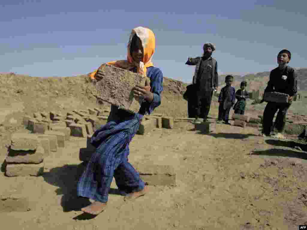 Internally displaced children work in a brick factory in the western Afghan city of Herat.