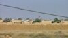 Iraqi security forces are seen outside Camp Ashraf after deadly fighting with residents in April 2011.