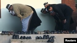 Muslim men pray at a mosque in the Tajik village of Nurabad on the holy day of Eid al-Adha.