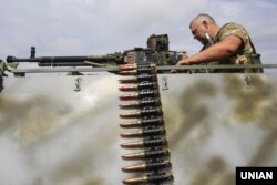 A Ukrainian soldier mans a machine gun near the front line in the east of the country. (file photo)