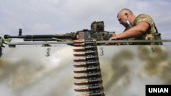 A Ukrainian serviceman mans a machine gun near the front line in the east of the country. (file photo)