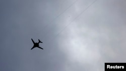 Syria -- An unidentified airplane flies over the Syrian town of Kobani, October 23, 2014