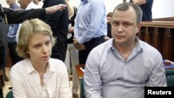 The children of journalist and human rights activist Anna Politkovskaya, Vera (left) and Ilya, look on before a court hearing in Moscow on June 3.