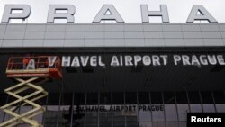 Czech Republic -- Workers install a sign for the new name of the Ruzyne airport in Prague, 26Sep2012