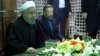 Iranian President Hassan Rohani (left) prays over the tomb of the founder of Iran's Islamic republic, Ayatollah Ruhollah Khomeini, in southern Tehran on January 31.