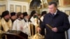 As the streets of Kyiv are convulsed with unrest, Ukrainian President Viktor Yanukovych (right) places a candle to mark the country's Day of Unity on January 22. 