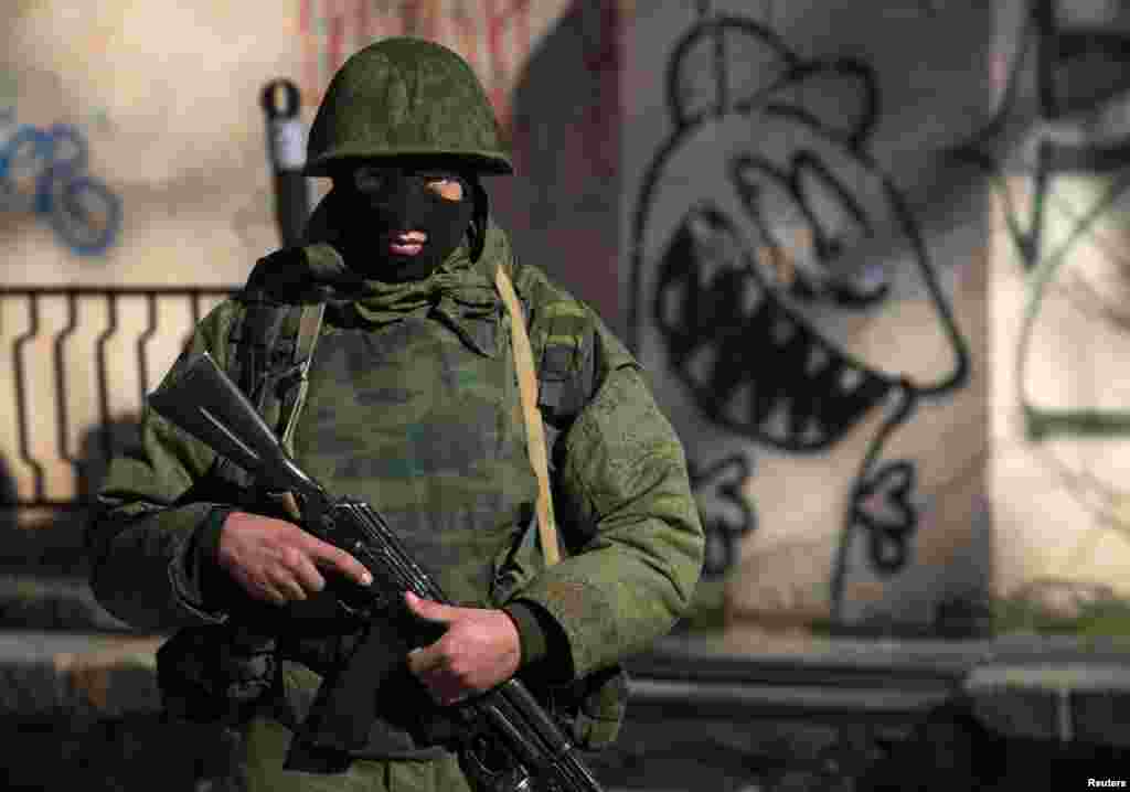 An armed man stands near a Ukrainian military base in Simferopol.