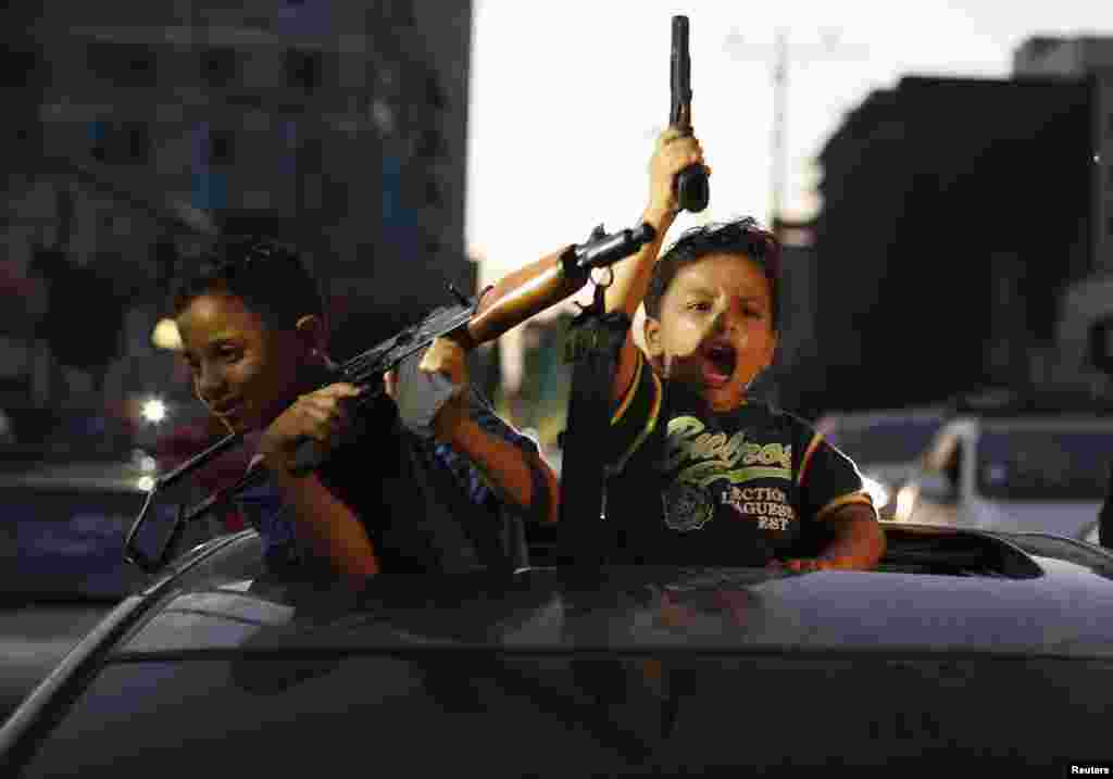 Palestinian children hold guns as they celebrate what they said was a victory over Israel following the declaration of a cease-fire in Gaza City on August 26. (Reuters/Suhaib Salem)