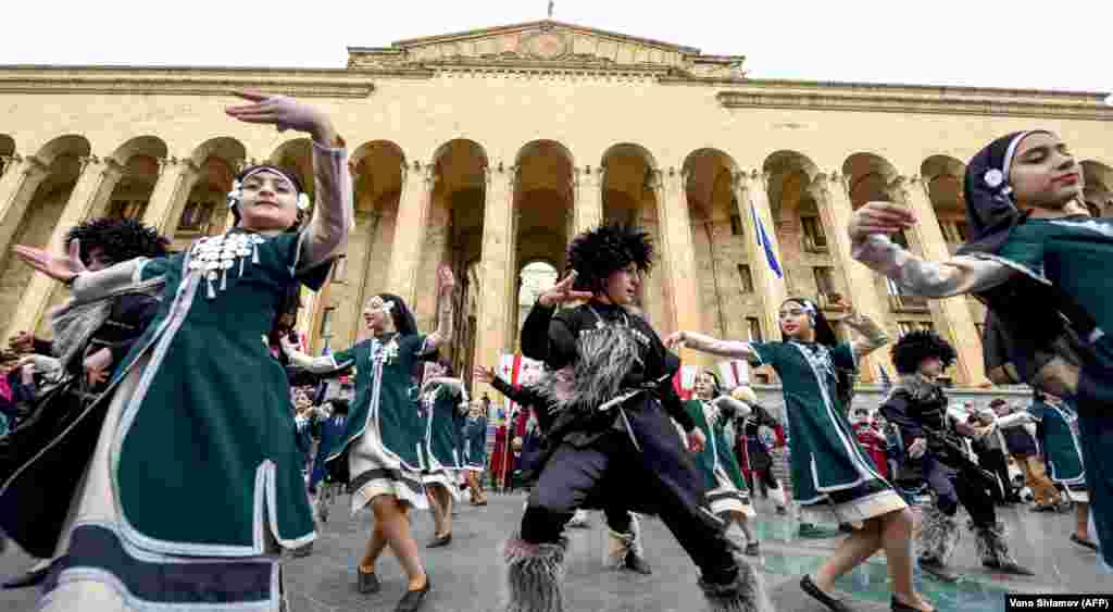Georgian children dance during an April 9 rally to commemorate the 30th anniversary of the so-called &quot;Tbilisi Tragedy,&quot; which occurred when an&nbsp;anti-Soviet&nbsp;demonstration was dispersed by the&nbsp;authorities in 1989, resulting in 21 deaths. (AFP/Vano Shlamov)