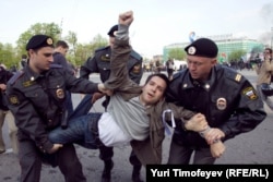 An opposition protester is detained by police in Bolotnaya Square in May 2012.