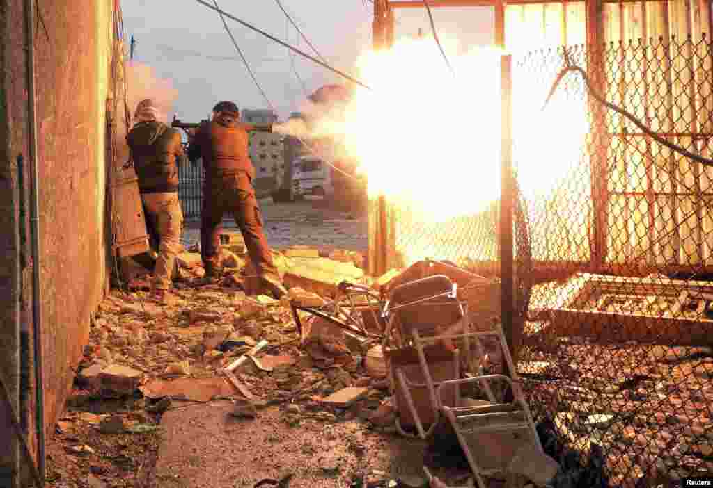 A Free Syrian Army fighter fires a rocket-propelled grenade during heavy fighting in Damascus, January 2013.