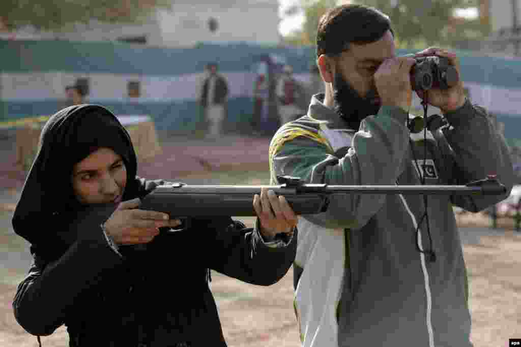 A young Pakistani woman demonstrates her shooting skills during the Khyber-Pakhtunkhwa All-Pakistan Shooting Challenge in Peshawar. (epa/Bilawal Arbab)